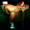 Vaquero Laced 3/4th Floral Wade by Keith Valley , 15&1/2 inch seat, Gullet - 7 and 1/2 inch by 6 and 1/4 inch by 4 inch, Horn 2&1/2 inch Metal Dally, 90 degree bars, 7/8ths flat palte riggin, Cheyenne Roll, Full Vaquero Lace Border with 3/4 floral tooling with black painted background. Saddle hand built by Keith Valley.